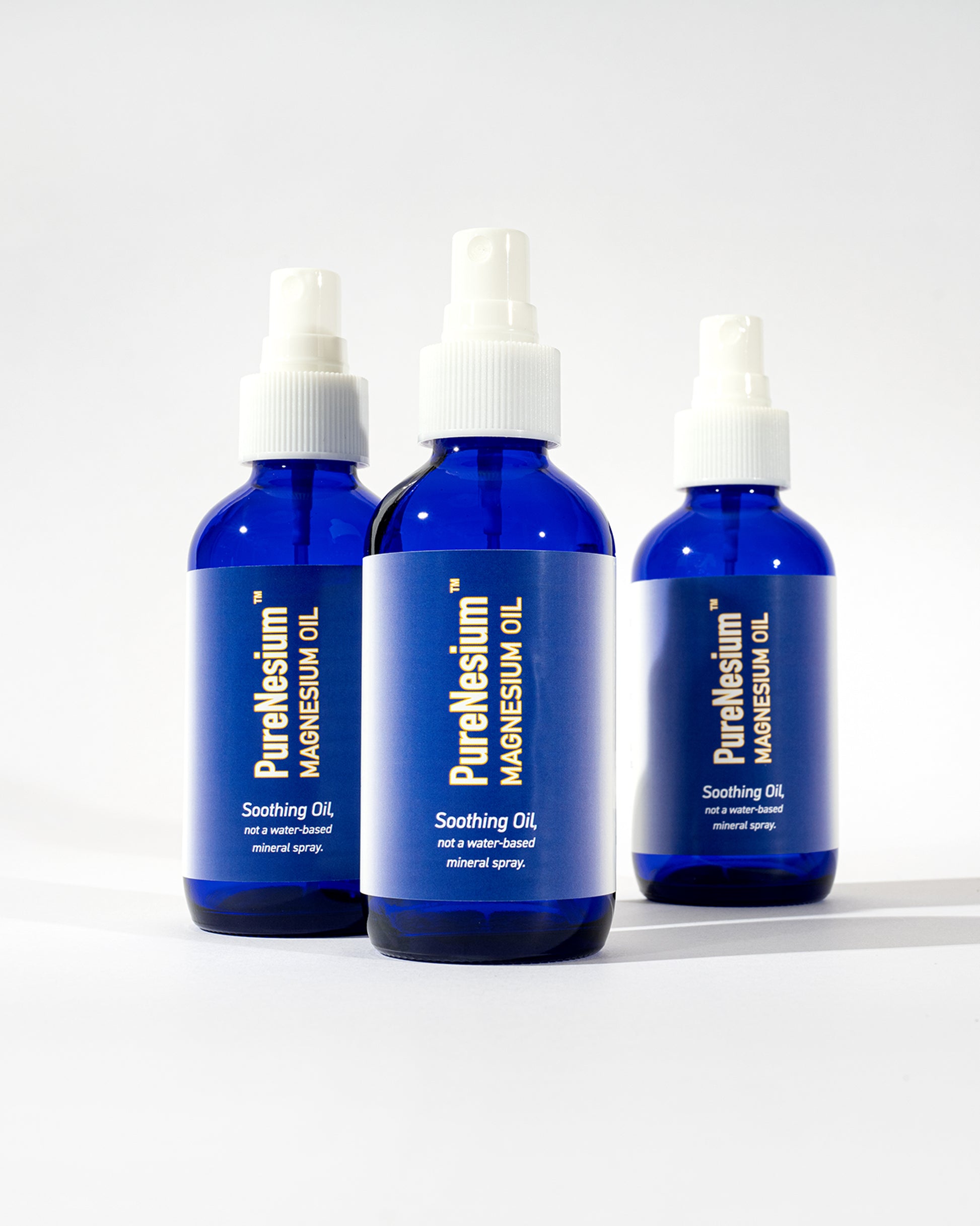 PureNesium Topical Magnesium Oil - three bottles group shot alternate